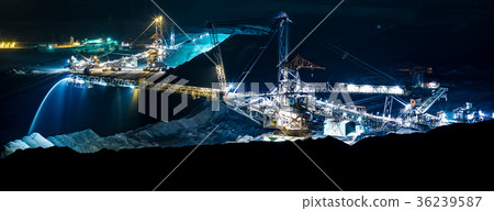 machine in an open coal mine at night 36239587