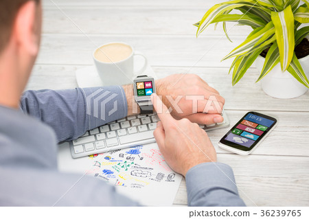 Businessman uses smart watch and phone. Businessman uses smart watch and phone. 36239765