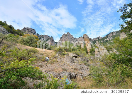 Tourists walk through a mountain gorge in the Tourists walk through a mountain gorge in the 36239837