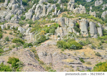 Tourists walk through a mountain gorge in the 36239854