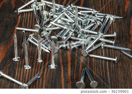 Construction nails on a wooden surface. 36239901
