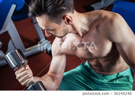 Handsome muscular man working out with dumbbells 36240246