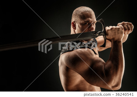 Severe barbarian in leather costume with sword Severe barbarian in leather costume with sword 36240541