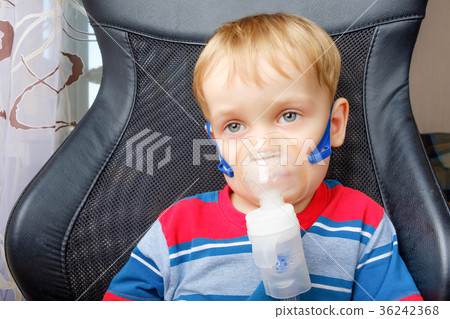 Boy making inhalation with a nebulizer Boy making inhalation with a nebulizer 36242368