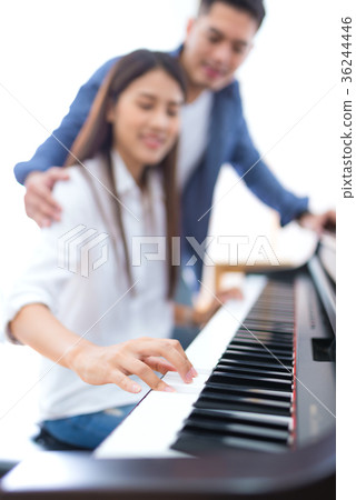 husband teaching his wife to play the piano husband teaching his wife to play the piano 36244446
