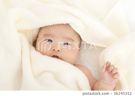 Baby wrapped in a towel 36245352
