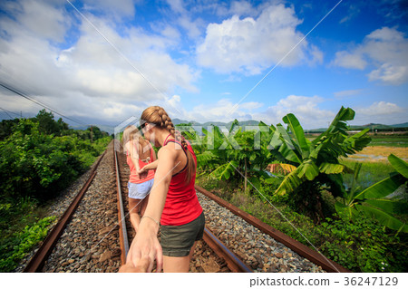 Blonde Girls Stand on Railway Track by Palms Blonde Girls Stand on Railway Track by Palms 36247129