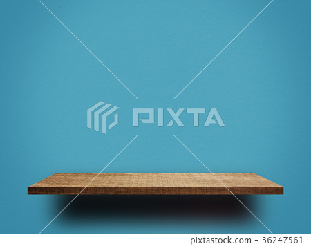 Empty wooden shelf on blue wall background 36247561