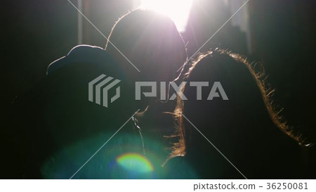 Young couple standing near window embracing Young couple standing near window embracing 36250081