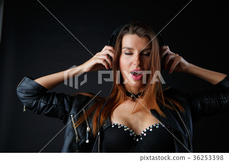 Picture of beautiful girl in headphones on black 36253398