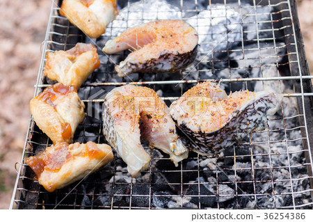 Fish steaks and chicken wings. 36254386