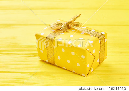 Yellow gift box on yellow background. Yellow gift box on yellow background. 36255610