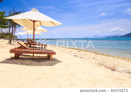 Chairs under White Umbrellas on Sand Beach by Sea 36255873