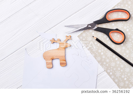 Cut out wooden deer, scissors, pencil. 36256192