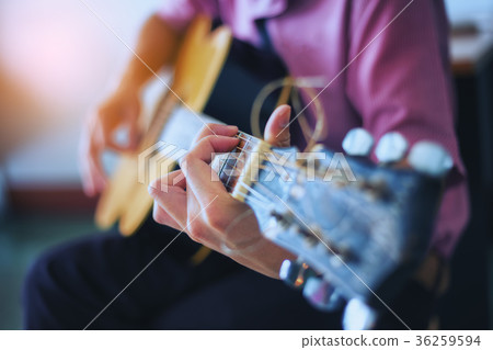 Musician is enjoying the guitar. Focus on fingers Musician is enjoying the guitar. Focus on fingers 36259594