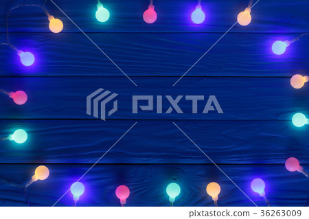 christmas garland lights on blue wooden background christmas garland lights on blue wooden background 36263009