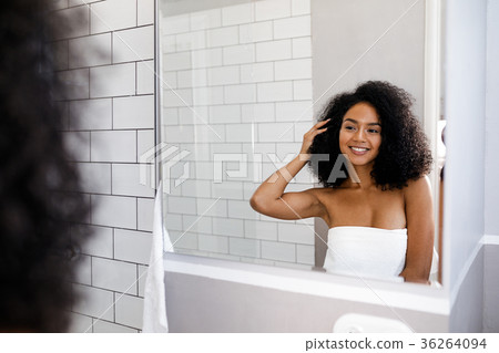 Shot of a young smiling woman in bathroom Shot of a young smiling woman in bathroom 36264094