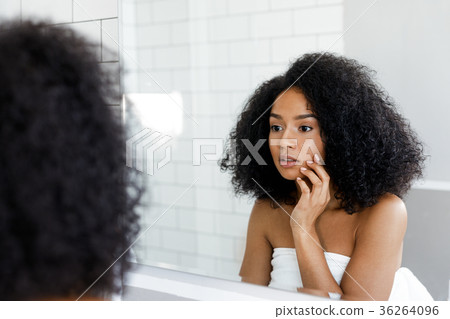 Attractive young woman touching her face Attractive young woman touching her face 36264096