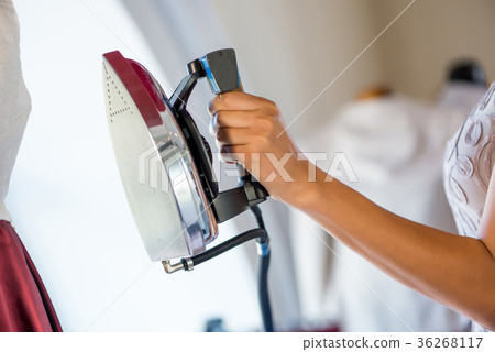 Woman holding iron 36268117