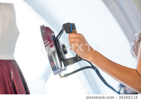 Woman holding iron 36268118