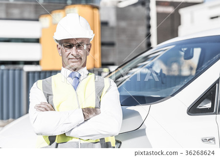 Senior builder man outdoors at construction site near his car lo Senior builder man outdoors at construction site near his car lo 36268624