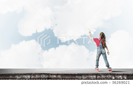 Concept of careless happy childhood with girl dreaming to become 36269021