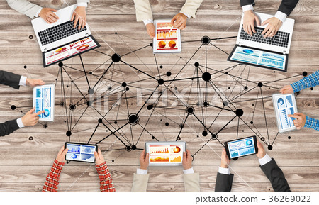 Top view of businesspeople sitting at table and using gadgets 36269022
