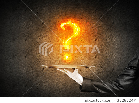 Hand of waitress presenting flaming question mark Hand of waitress presenting flaming question mark 36269247