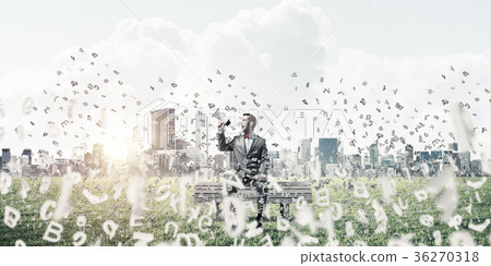 Businessman in summer park on bench announcing something in loud Businessman in summer park on bench announcing something in loud 36270318