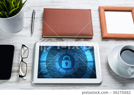 Web security and technology concept with tablet pc on wooden table Web security and technology concept with tablet pc on wooden table 36270882