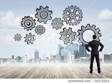 Cogwheel engine drawn on screen as symbol for teamwork and cooperation Cogwheel engine drawn on screen as symbol for teamwork and cooperation 36272014