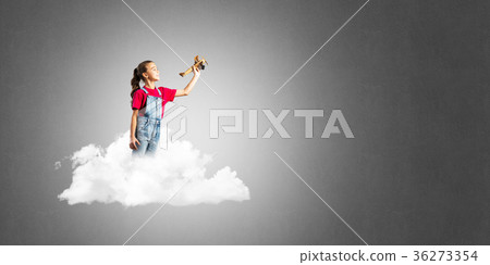 Concept of careless happy childhood with girl dreaming to become pilot Concept of careless happy childhood with girl dreaming to become pilot 36273354