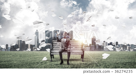 Businessman in summer park announcing something in loudspeaker a Businessman in summer park announcing something in loudspeaker a 36274235