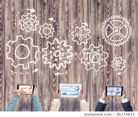 Top view of businesspeople sitting at table and using gadgets 36274815