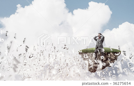 Young man floating in sky and dont want to hear anything 36275654