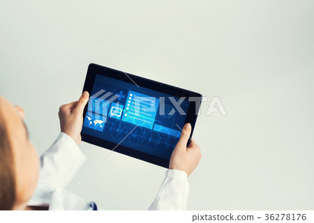 Close of female doctor hands working with tablet pc computer Close of female doctor hands working with tablet pc computer 36278176