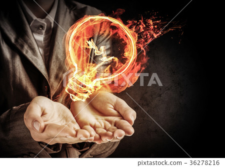 Businessman presenting flaming lightbulb. Businessman presenting flaming lightbulb. 36278216