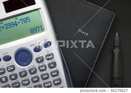 Calculator and pen on notebook close up 36279027
