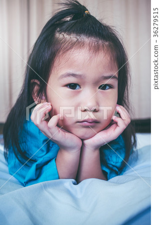 Unhappy illness asian child admitted in hospital. 36279515