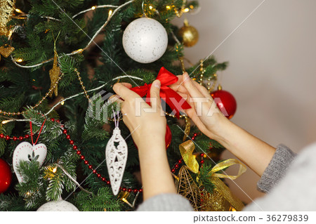 Girl decorates Christmas tree. Girl decorates Christmas tree. 36279839