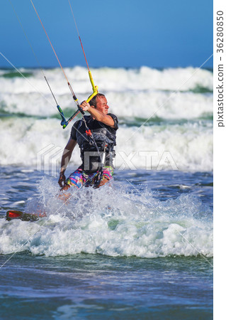 Young atletic man riding kite surf on a sea 36280850