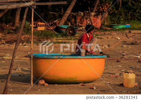 Asian Boy in Red T-shirt Sits in Round Orange Boat 36281341