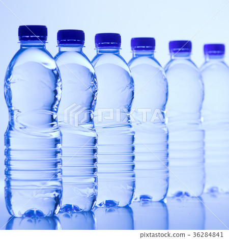 Plastic bottles of water isolated on blue Plastic bottles of water isolated on blue 36284841