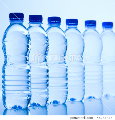 Plastic bottles of water isolated on blue 36284842