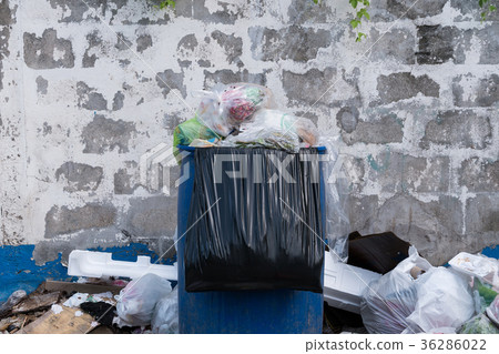 Dumpsters being full with garbage in the evening 36286022
