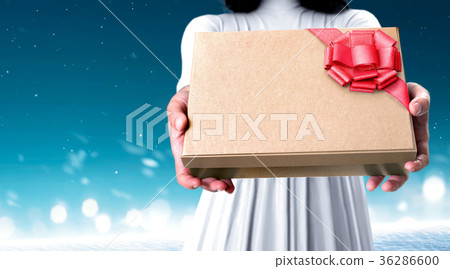 Woman with gift in her hand tied with red ribbon Woman with gift in her hand tied with red ribbon 36286600