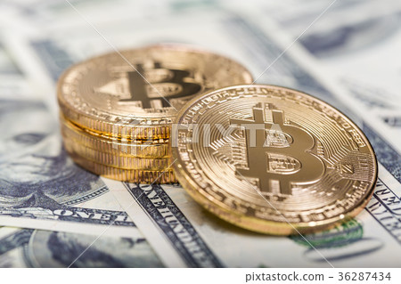 Bitcoins on dollar banknotes background Bitcoins on dollar banknotes background 36287434