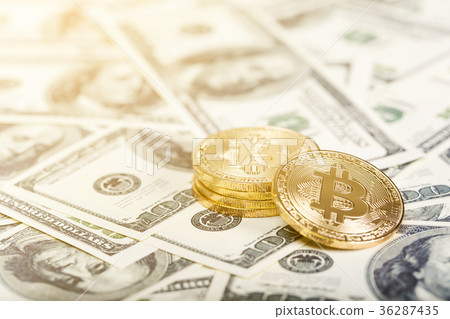 Bitcoins on dollar banknotes background 36287435