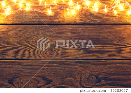 Picture of wooden surface with burning garland on 36288037