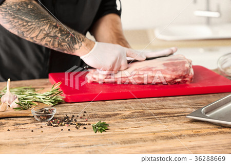 Man cooking meat steak on kitchen Man cooking meat steak on kitchen 36288669